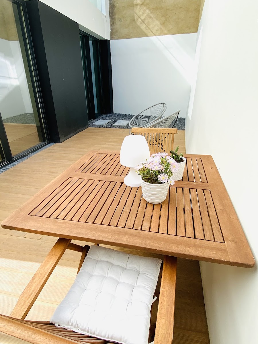 Outdoor patio with table and chairs at Aljube Residences
